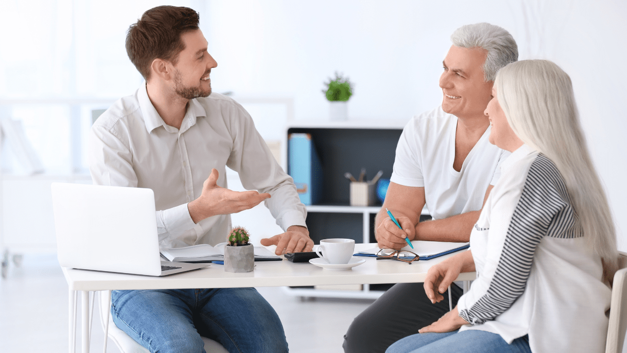 A family discussing financial plans with a financial advisor at Brookstone Financial in Jeffersonville, IN.