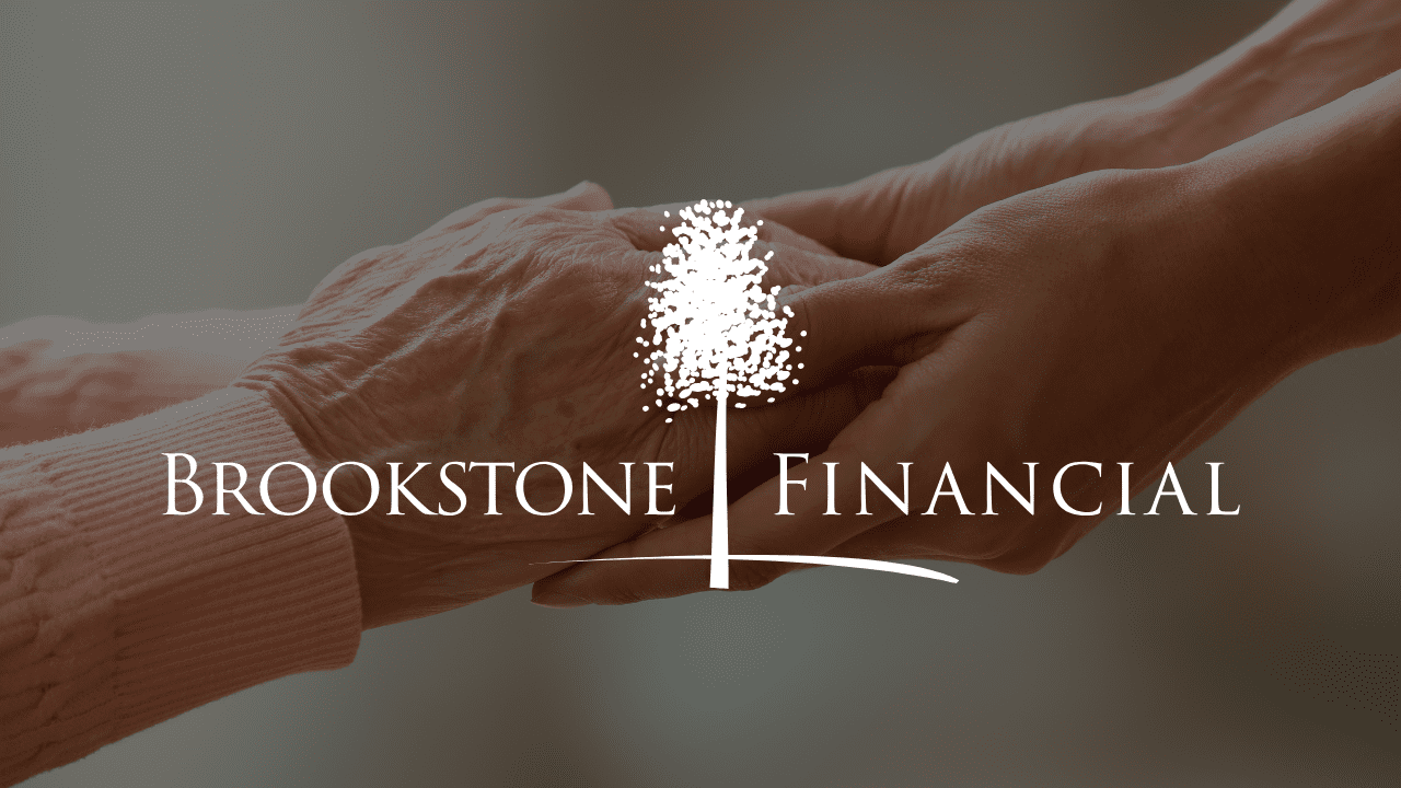 An older person holding the hand of a younger person, symbolizing support, guidance, and charitable giving.