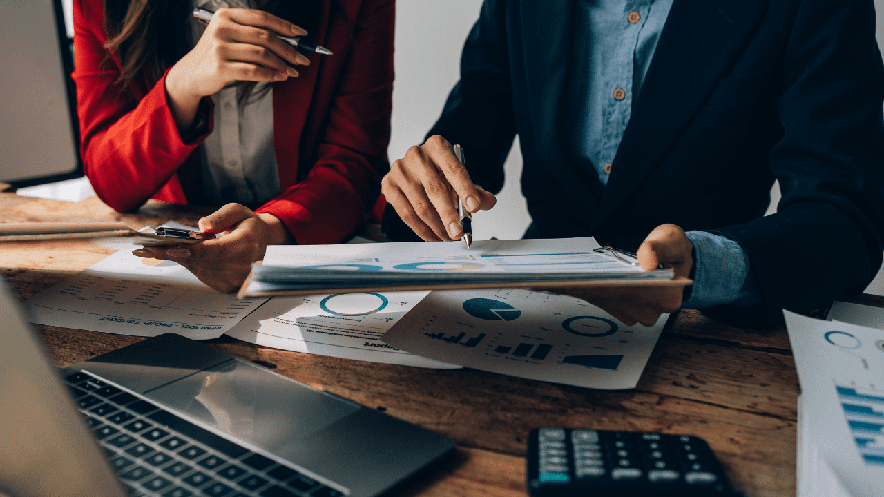 A financial advisor from Brookstone Financial in Jeffersonville, IN, discussing investment strategies with a client using advanced digital tools and data analytics.