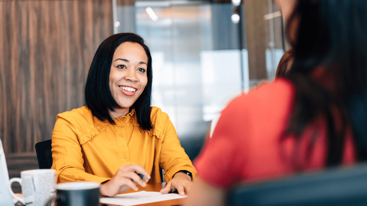 A professional financial advisor discussing long-term financial strategies with a woman.